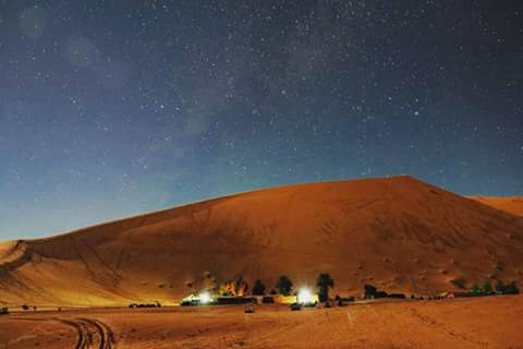 A desert camp beneath a star-filled sky in Merzouga